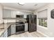 This kitchen has stainless steel appliances, granite countertops, and luxury vinyl plank flooring at 5257 Glenlea Walk Ln, Charlotte, NC 28216