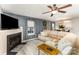 Open concept living room with fireplace, wainscoting, and open to the dining area and kitchen at 5257 Glenlea Walk Ln, Charlotte, NC 28216
