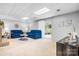 Finished basement with a decorative ceiling, plush blue sofas, and access to a sunroom at 5486 Suttlemyre Ln, Hickory, NC 28601