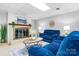 Inviting basement space with plush blue sofas, a brick fireplace, and warm decorative lighting at 5486 Suttlemyre Ln, Hickory, NC 28601