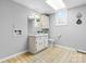 Simple bathroom with a white vanity, neutral tile floors, a patterned ceiling, and a laundry hook-up at 5486 Suttlemyre Ln, Hickory, NC 28601
