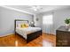 Cozy bedroom with hardwood floors, a decorative headboard, and bright natural light from the window at 5486 Suttlemyre Ln, Hickory, NC 28601