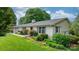 Charming home with white brick, grey shutters, and well-maintained landscaping at 5486 Suttlemyre Ln, Hickory, NC 28601