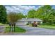 Single-story home featuring a brick exterior, green lawn, and mature trees adding curb appeal at 5486 Suttlemyre Ln, Hickory, NC 28601