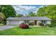 Charming single-story home with a well-manicured lawn, mature trees, and a brick exterior at 5486 Suttlemyre Ln, Hickory, NC 28601