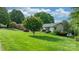 Well-manicured front yard featuring lush green grass and mature trees, creating a welcoming curb appeal at 5486 Suttlemyre Ln, Hickory, NC 28601