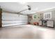 Spacious garage with an open overhead door, windows, and ample storage space for vehicles and equipment at 5486 Suttlemyre Ln, Hickory, NC 28601