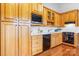 Bright kitchen with wood cabinets, white countertops, and black appliances at 5486 Suttlemyre Ln, Hickory, NC 28601