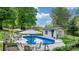 Backyard oasis featuring a fenced in-ground pool and outdoor seating area at 5486 Suttlemyre Ln, Hickory, NC 28601