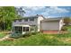 View of the back of the property, featuring a screened in porch with steps leading to the manicured lawn at 5486 Suttlemyre Ln, Hickory, NC 28601