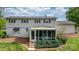 Back of the two story home with a screened in porch and manicured lawn and landscaping at 5486 Suttlemyre Ln, Hickory, NC 28601