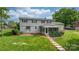 The backyard of this two story home features a screened in porch and a landscaped lawn at 5486 Suttlemyre Ln, Hickory, NC 28601