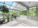 Light-filled sunroom with walls of windows, glass ceilings, and potted greenery creating a serene indoor oasis at 5486 Suttlemyre Ln, Hickory, NC 28601