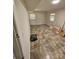 Spacious basement area with ceramic tile flooring, natural lighting, and access to the outside at 6212 Snowcrest Ct, Charlotte, NC 28212