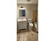 Cozy bathroom showcasing ceramic tile flooring, classic fixtures, and a functional vanity with storage at 6212 Snowcrest Ct, Charlotte, NC 28212