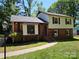 Charming two-story home featuring brick and vinyl siding, with a well-maintained front lawn and mature trees at 6212 Snowcrest Ct, Charlotte, NC 28212