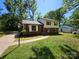 Charming two-story home featuring brick and vinyl siding, with a well-maintained front lawn and mature trees at 6212 Snowcrest Ct, Charlotte, NC 28212