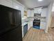 Updated kitchen with white cabinets, granite countertops, and stainless steel appliances at 6212 Snowcrest Ct, Charlotte, NC 28212