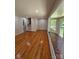 Open-concept living space with hardwood floors, featuring a large bay window and staircase access at 6212 Snowcrest Ct, Charlotte, NC 28212