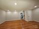 Bright, empty living room with hardwood floors and neutral walls, offering versatility and clean design at 6212 Snowcrest Ct, Charlotte, NC 28212