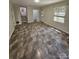 Expansive living space with ceramic tile flooring, multiple windows, and transitional areas at 6212 Snowcrest Ct, Charlotte, NC 28212