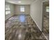 Bright living room with ceramic tile flooring and large windows for natural light at 6212 Snowcrest Ct, Charlotte, NC 28212