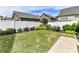 Manicured lawn with a white fence and decorative bushes on a sunny day at 6312 Kennard Dr, Charlotte, NC 28216