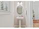 Powder room with a pedestal sink, decorative mirror, and modern fixtures at 6312 Kennard Dr, Charlotte, NC 28216