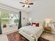Bright bedroom with a ceiling fan, oriental rug, and a window view of the outdoors at 6312 Kennard Dr, Charlotte, NC 28216