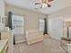 Cozy Bedroom with a white crib, dresser, and ample natural light streaming through the windows at 6312 Kennard Dr, Charlotte, NC 28216