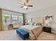 Bright bedroom showcasing a tufted headboard, blue accents, and sun-filled windows with a neighborhood view at 6312 Kennard Dr, Charlotte, NC 28216