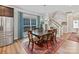 Dining area featuring hardwood floors, a large window and staircase at 6312 Kennard Dr, Charlotte, NC 28216