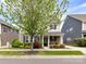 Charming two-story home featuring beautifully landscaped front yard and gray siding with black shutters at 6312 Kennard Dr, Charlotte, NC 28216