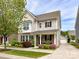 Charming two-story home featuring beautiful landscaping, a covered front porch, and a detached garage at 6312 Kennard Dr, Charlotte, NC 28216