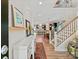 Open foyer with hardwood floors, staircase, leading to the kitchen and dining room at 6312 Kennard Dr, Charlotte, NC 28216