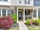 Charming home with beautifully landscaped front yard and welcoming front porch with seating at 6312 Kennard Dr, Charlotte, NC 28216