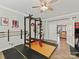 Home gym with weightlifting equipment, ceiling fan, and rubber flooring at 6312 Kennard Dr, Charlotte, NC 28216