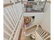 Bright, open staircase featuring wood treads, white risers and railing, and a view of the dining room below at 6312 Kennard Dr, Charlotte, NC 28216