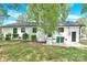 A view of the backyard with manicured bushes and a door leading into the home at 6600 Knightswood Dr, Charlotte, NC 28226