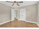 Bedroom featuring hardwood floors, neutral walls, closet, and modern ceiling fan at 6600 Knightswood Dr, Charlotte, NC 28226