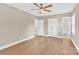 Bright bedroom with hardwood floors, neutral walls, closet, and view into an ensuite bathroom at 6600 Knightswood Dr, Charlotte, NC 28226