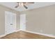 Bedroom with neutral walls, hardwood flooring, a ceiling fan, and double door closet at 6600 Knightswood Dr, Charlotte, NC 28226