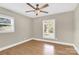 Bedroom featuring hardwood floors, neutral walls, a ceiling fan, and natural light from two windows at 6600 Knightswood Dr, Charlotte, NC 28226