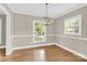 Dining room with hardwood floors, neutral paint and modern chandelier at 6600 Knightswood Dr, Charlotte, NC 28226