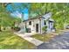 A view of the side and back exterior, with a chimney and a small patio at 6600 Knightswood Dr, Charlotte, NC 28226