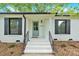 Inviting front porch with a light blue door and black iron railings leading up to the entryway at 6600 Knightswood Dr, Charlotte, NC 28226