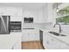 Modern kitchen featuring white cabinets, stainless steel appliances, and quartz countertops at 6600 Knightswood Dr, Charlotte, NC 28226