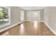 Spacious living room with hardwood floors, neutral paint, and abundant natural light at 6600 Knightswood Dr, Charlotte, NC 28226