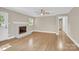 Spacious, well-lit living room with fireplace, hardwood flooring, and neutral walls at 6600 Knightswood Dr, Charlotte, NC 28226