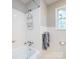 Bathroom features a tub/shower combo, toilet, and vanity with a window for natural light at 6616 Williams Rd, Charlotte, NC 28215
